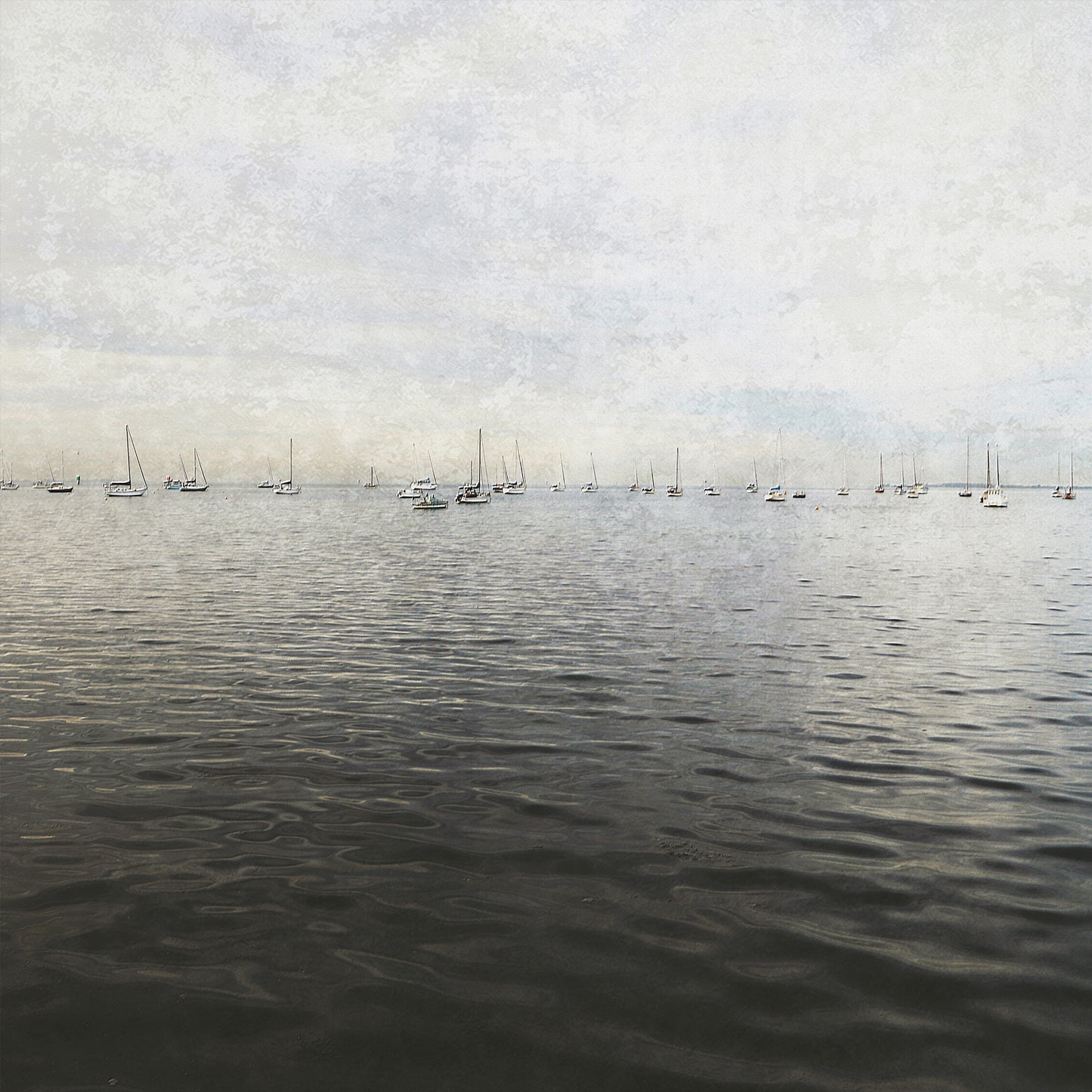 Peaceful print in muted tones  of the ocean with yachts in the far distance